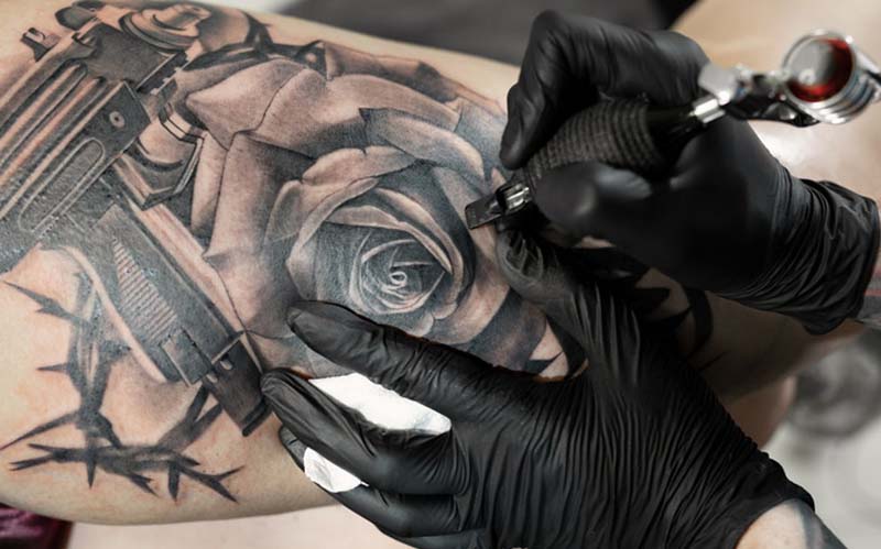 Man getting a sleeve tattoo at a tattoo shop Las Vegas.