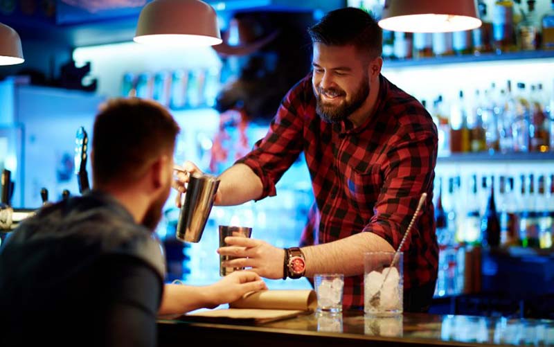 Patron giving the bartender a tip at Fremont Street bar.